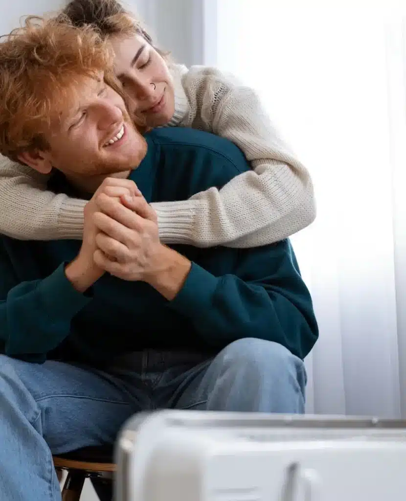 Couple enjoying togetherness in their cozy home after installing a central heating system in Bolton